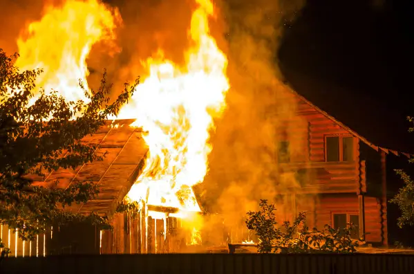 Residential structure fire causing active flames and heavy smoke